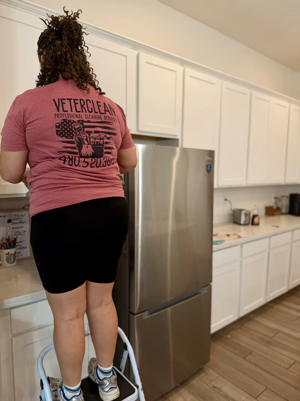 Weekly house cleaning service wiping kitchen counters in a Gilbert AZ home